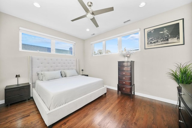 bedroom featuring visible vents, baseboards, and wood finished floors