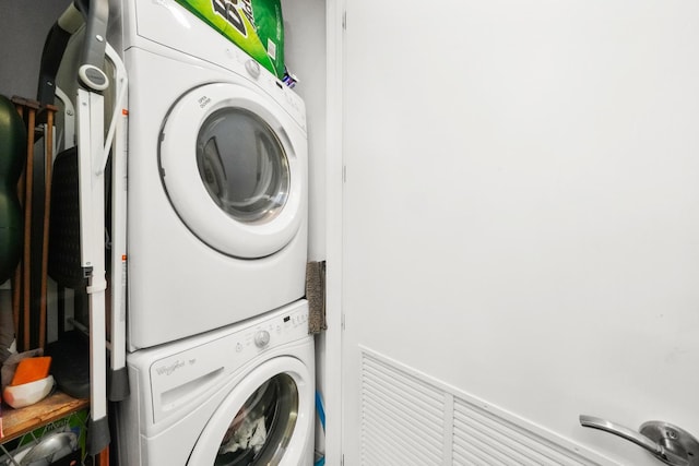 washroom featuring laundry area and stacked washer / dryer