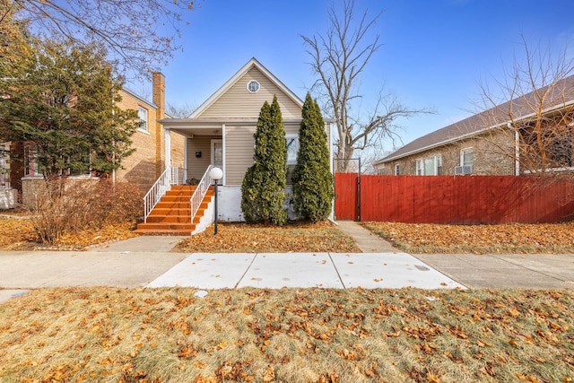 view of front facade with a porch and fence