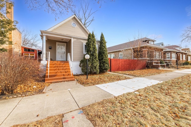 view of front of home featuring fence and a porch