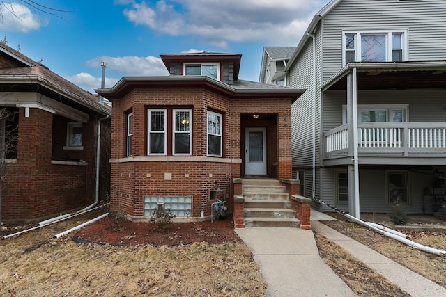 view of front of house featuring entry steps and brick siding