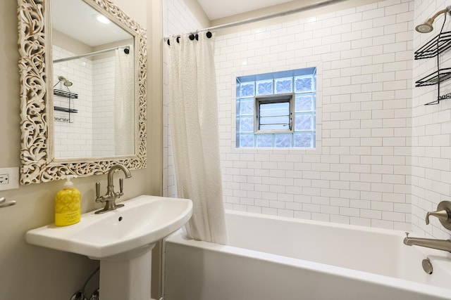 bathroom featuring a sink and shower / bath combo with shower curtain