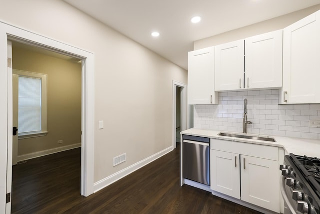 kitchen featuring visible vents, decorative backsplash, appliances with stainless steel finishes, light countertops, and a sink