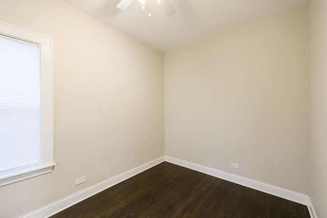 unfurnished room with dark wood-style floors, baseboards, and a ceiling fan