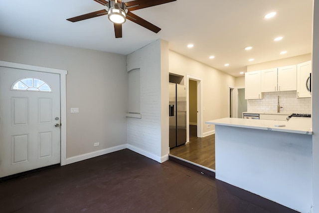 kitchen with recessed lighting, light countertops, backsplash, appliances with stainless steel finishes, and white cabinets