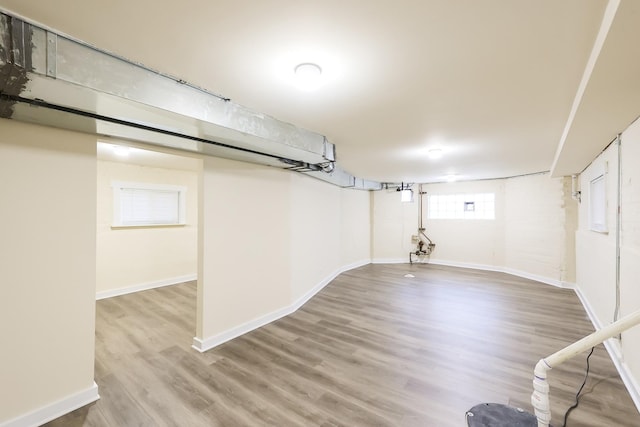 below grade area with wood finished floors and baseboards