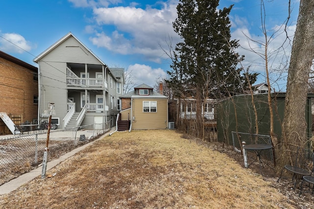 back of house featuring a balcony, fence private yard, and cooling unit