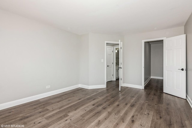 unfurnished bedroom with baseboards and wood finished floors