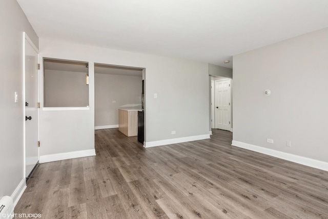 interior space with baseboards and wood finished floors