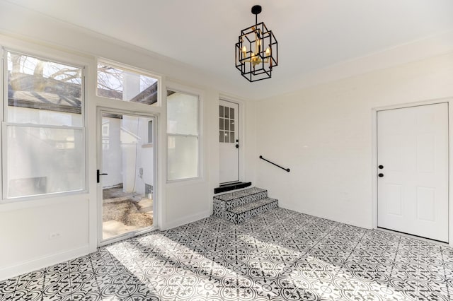 entryway with a chandelier, baseboards, and light tile patterned floors