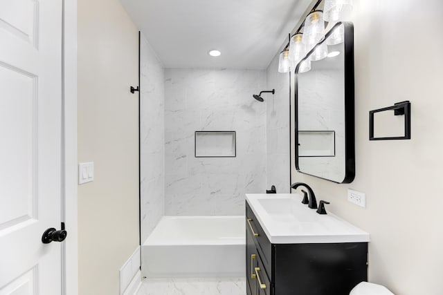 bathroom featuring  shower combination, marble finish floor, recessed lighting, and vanity