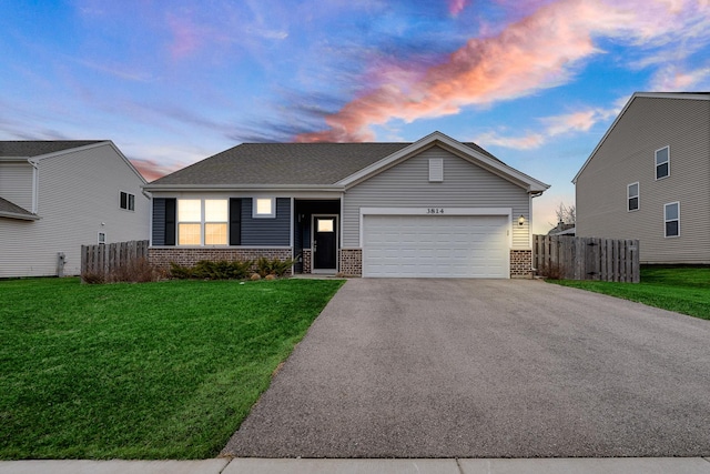 ranch-style home featuring aphalt driveway, brick siding, a yard, fence, and a garage