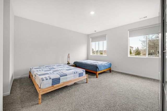 bedroom with carpet, visible vents, and baseboards