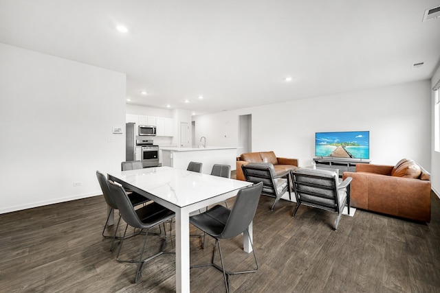 dining area with visible vents, baseboards, dark wood finished floors, and recessed lighting