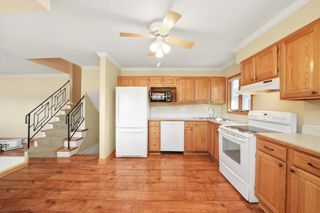 kitchen with light countertops, light wood-style floors, a sink, white appliances, and under cabinet range hood