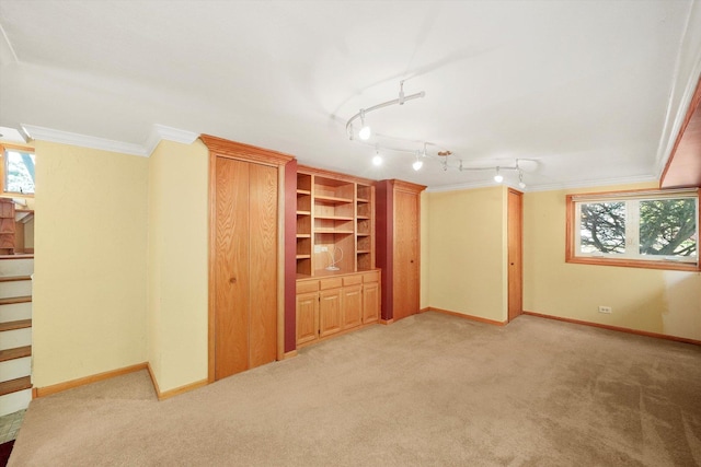 interior space with ornamental molding, light colored carpet, baseboards, and stairs