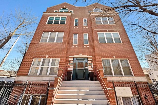 exterior space featuring fence and brick siding