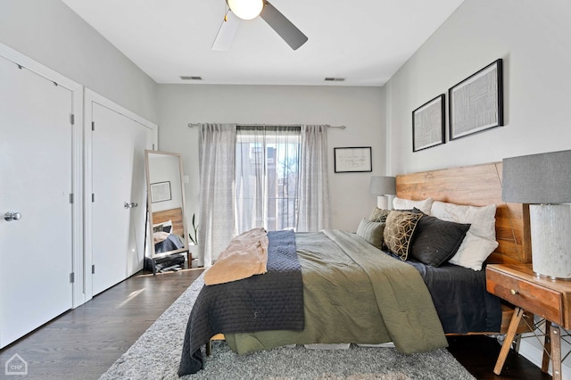 bedroom with visible vents, dark wood finished floors, and ceiling fan