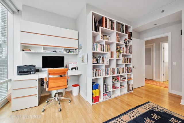 office space featuring wood finished floors and baseboards