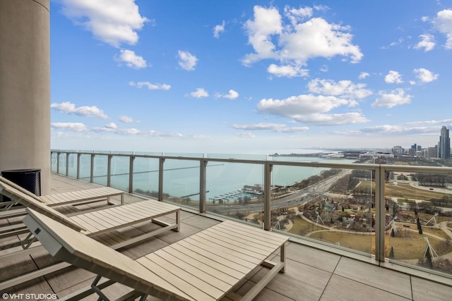 balcony with a water view and a city view