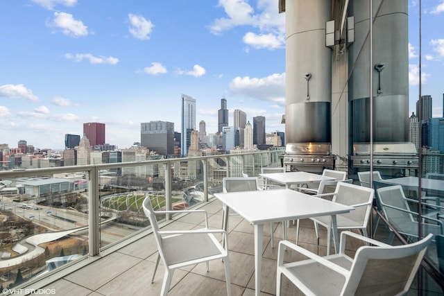 balcony featuring a city view and a grill