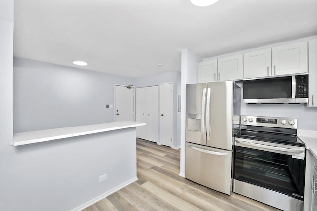 kitchen featuring stainless steel appliances, light wood-type flooring, light countertops, and white cabinetry