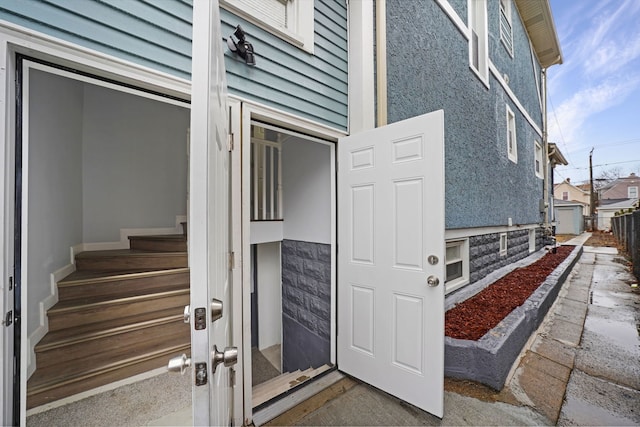 view of exterior entry featuring stucco siding