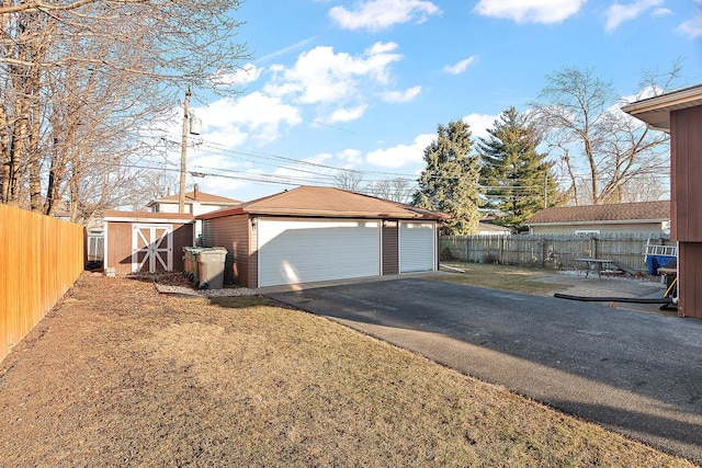 detached garage featuring fence