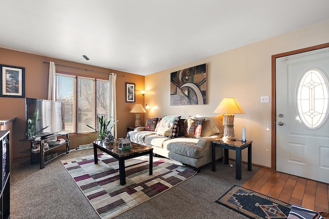 carpeted living area featuring baseboards