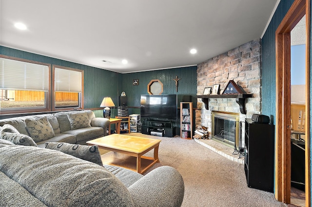 carpeted living room featuring recessed lighting and a stone fireplace