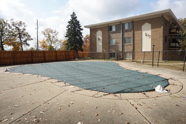 view of swimming pool featuring a fenced in pool, fence, and a patio