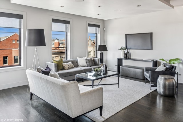 living room featuring recessed lighting, dark wood finished floors, and baseboards