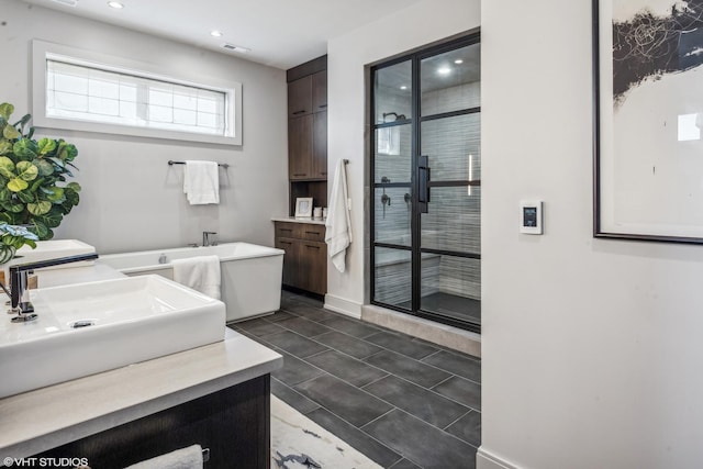 full bathroom featuring visible vents, a freestanding bath, vanity, tile patterned flooring, and walk in shower