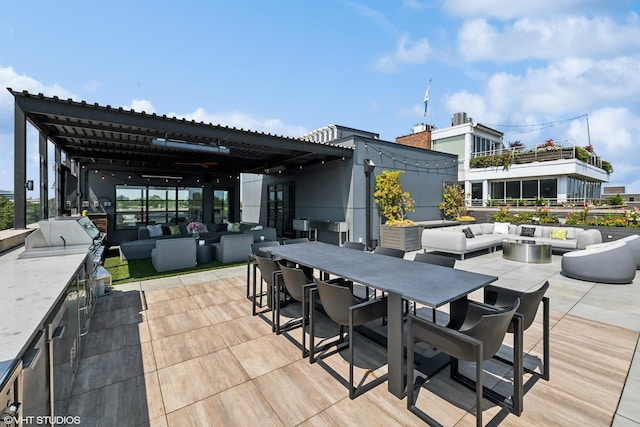 view of patio with outdoor dining space, exterior kitchen, and an outdoor living space