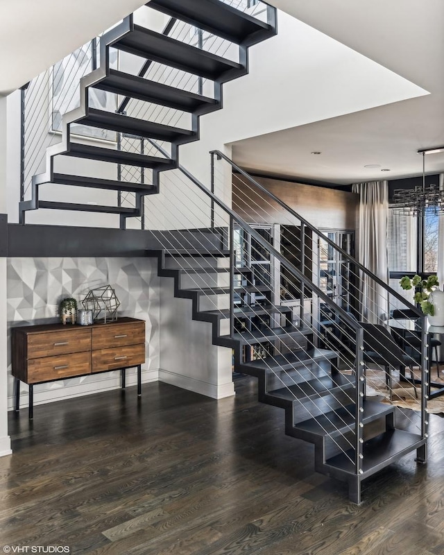 stairway featuring wood finished floors and baseboards