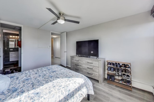 bedroom with a ceiling fan, light wood-type flooring, and baseboards