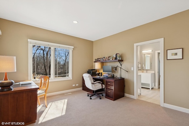 carpeted office space with baseboards