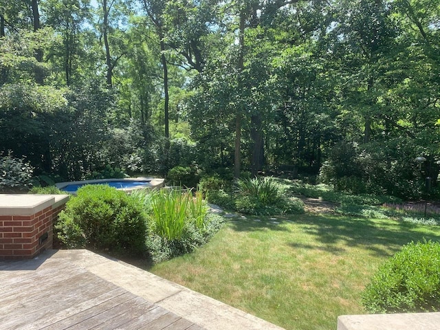 view of yard with a hot tub and a deck