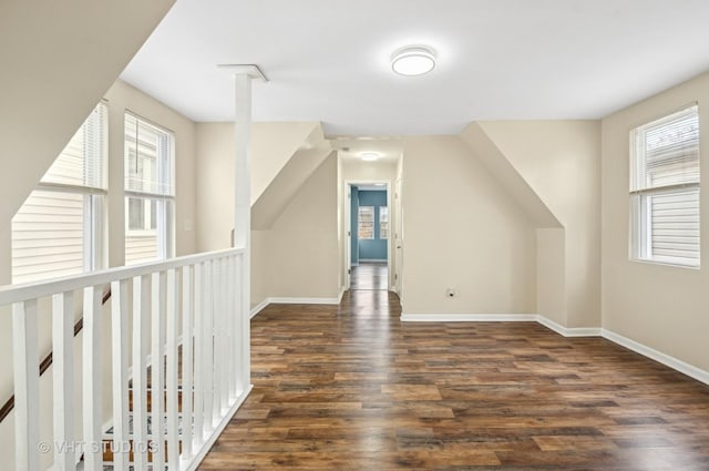 bonus room with vaulted ceiling, wood finished floors, and baseboards