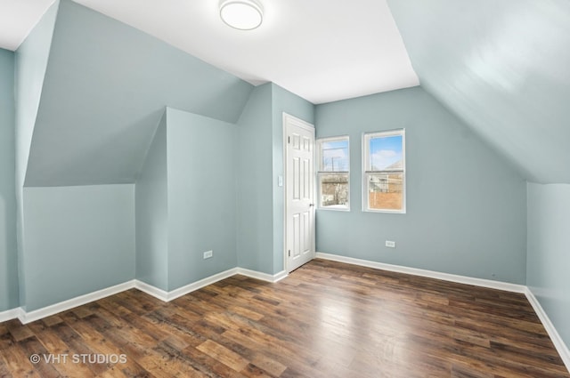 bonus room with lofted ceiling, wood finished floors, and baseboards