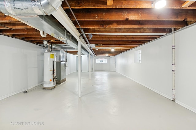 below grade area featuring water heater and baseboards