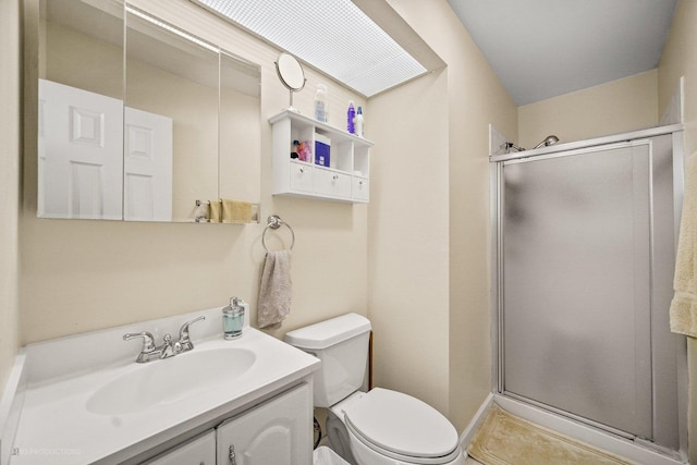 bathroom featuring tile patterned flooring, toilet, vanity, baseboards, and a shower stall