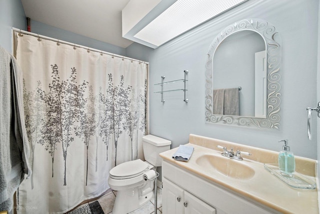 bathroom with a shower with curtain, vanity, toilet, and tile patterned floors