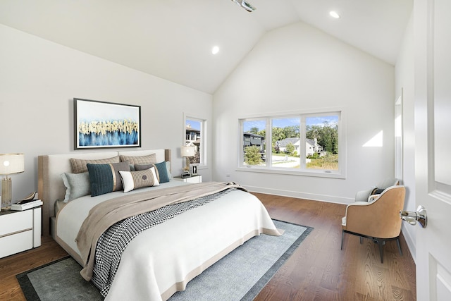 bedroom with high vaulted ceiling, recessed lighting, baseboards, and wood finished floors