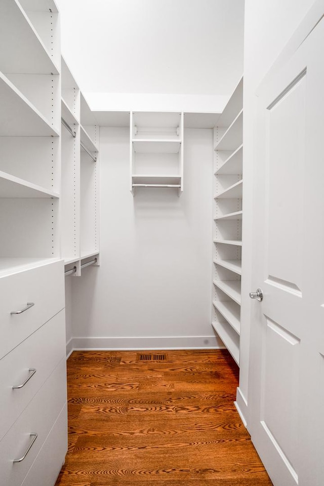 walk in closet featuring visible vents and dark wood-type flooring