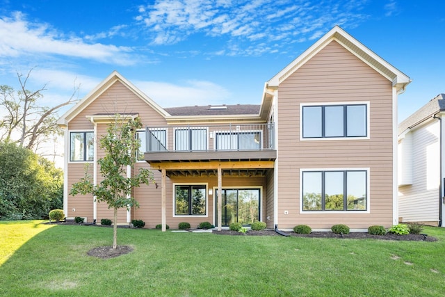 back of house featuring a yard and a wooden deck