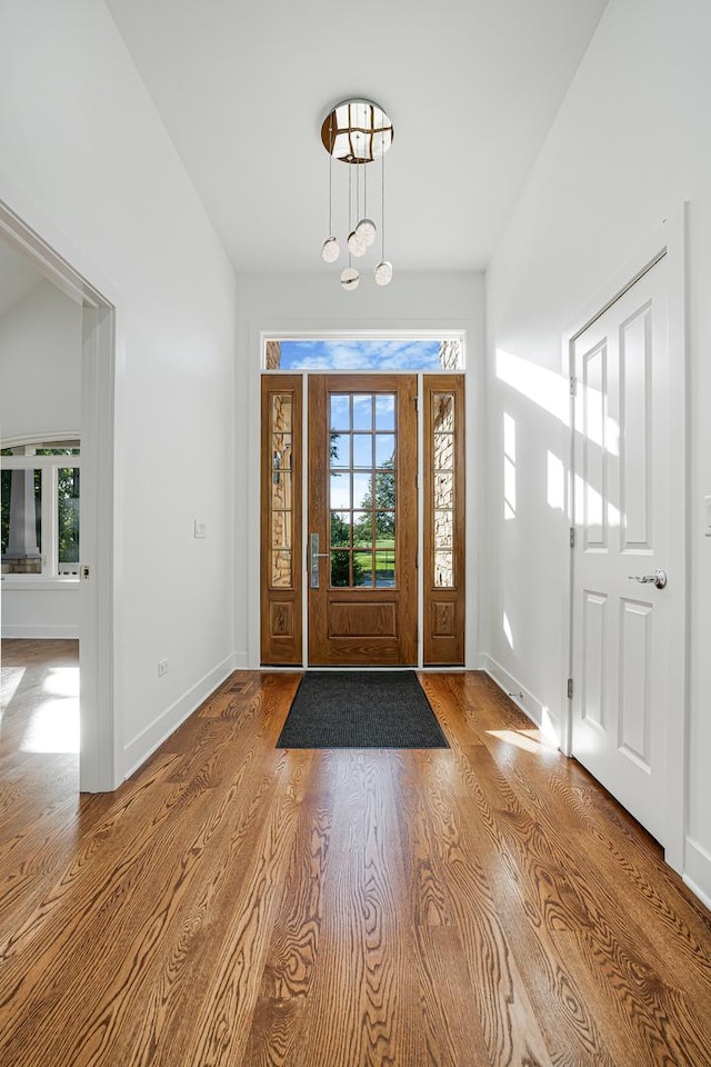 entryway featuring baseboards and wood finished floors