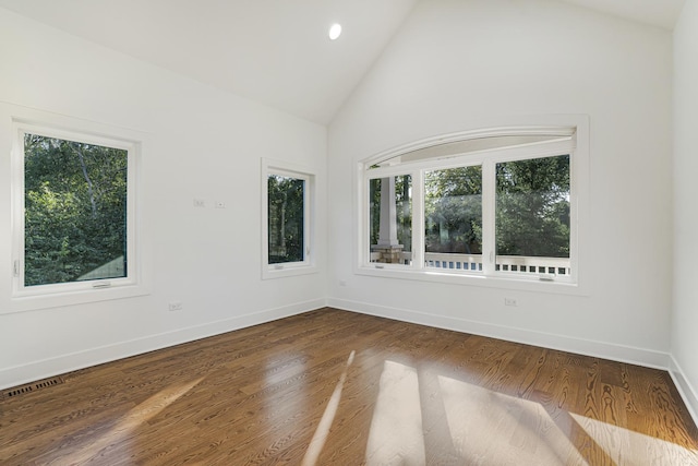 unfurnished room with high vaulted ceiling, plenty of natural light, baseboards, and dark wood finished floors