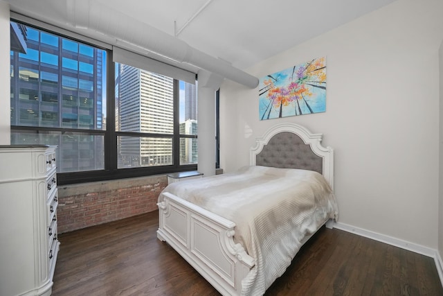 bedroom with dark wood-style floors and baseboards