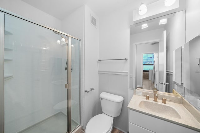 bathroom featuring a stall shower, visible vents, vanity, and toilet